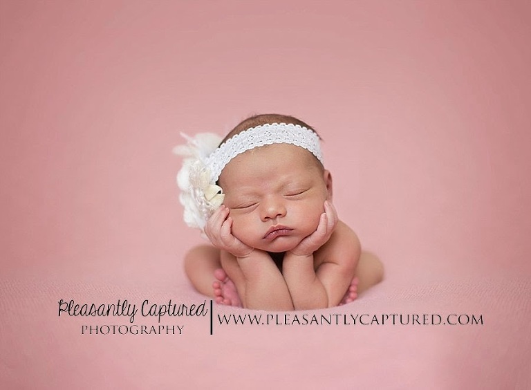 Newborn girl head in hands composite image - Jacksonville NC professional newborn photographer