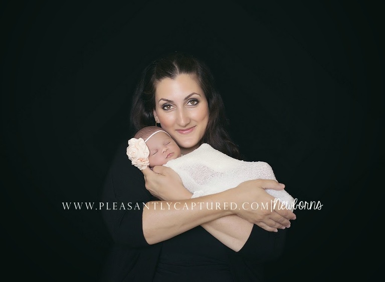 Happy mother posing with newborn daughter - Newborn baby photographer wilmington NC