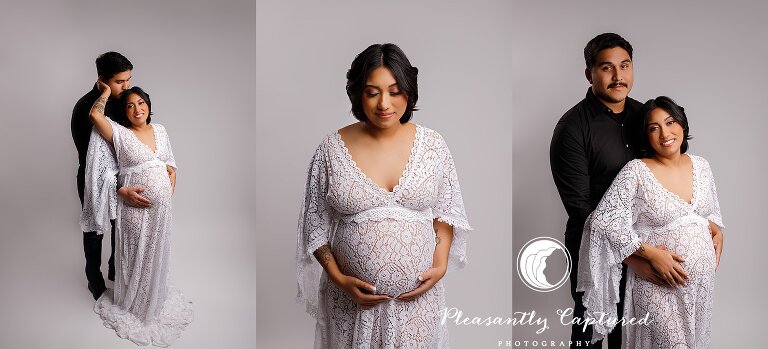 Pregnant mother wearing white dress and being held by father to be at nc maternity photographer studio
