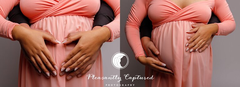 Pregnant mother wearing pink dress and holding hands on belly at nc maternity photographer studio