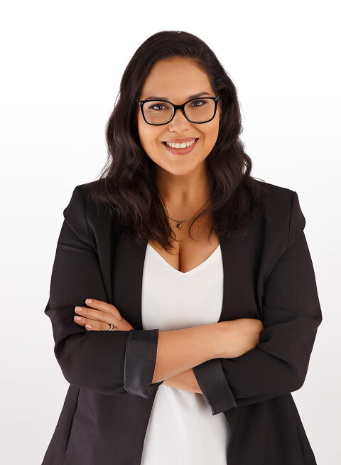 professional headshot of woman in black blazer against a white backdrop