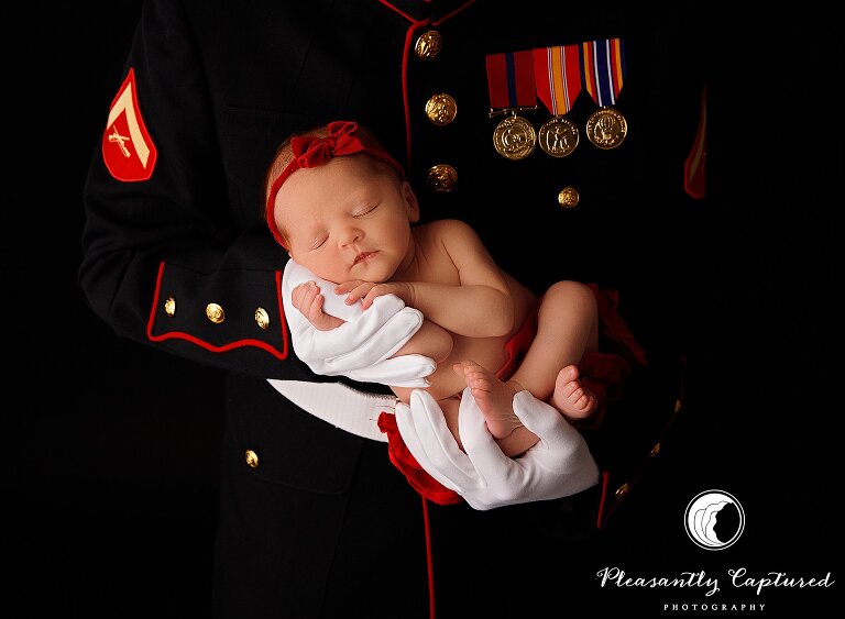 Newborn girl clings to dads finger who is in marine corps dress blues uniform - Sneads Ferry Newborn Photography | New Family of 3