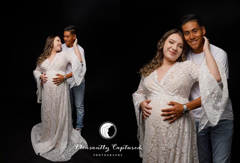 Beautiful mother to be in white lace gown against black background with spouse holding pregnant belly maternity photography jacksonville nc