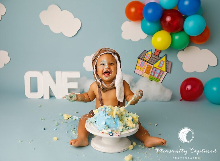 boy making a mess with cake during Up Themed Cake Smash | Birthday Photography Jacksonville NC