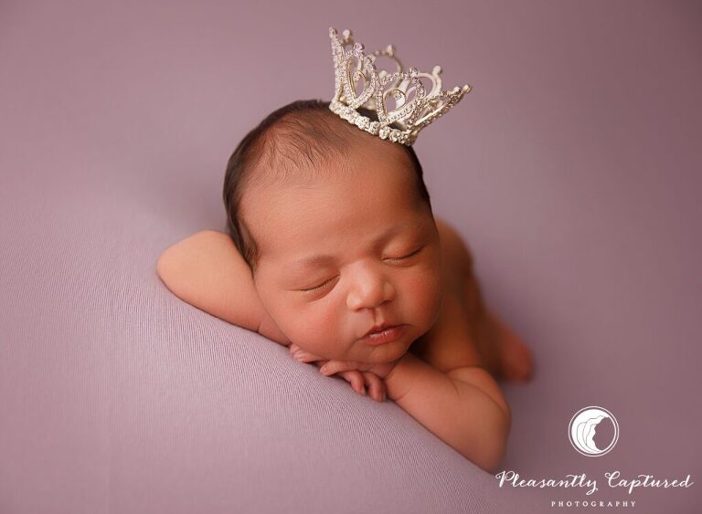 Newborn baby girl wearing crown on purple fabric - richlands nc Newborn photographer