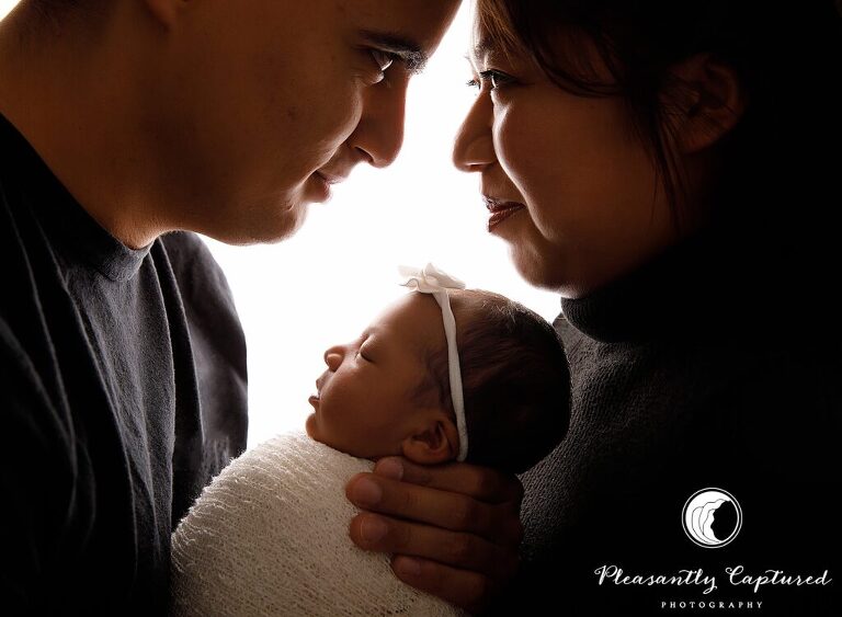 New parents snuggling their newborn daughter - richlands nc Newborn photographer
