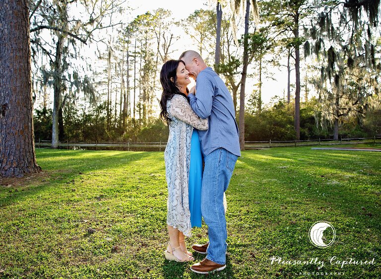 Husband and wife embrace each other and laugh at Marston Pavilion Camp lejeune couple photographer