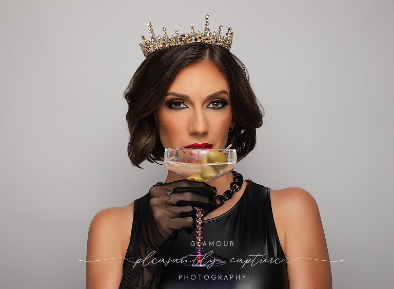 Glamour studio portrait of birthday queen in gold accessories and dramatic lighting in Jacksonville NC