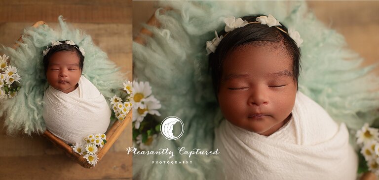 Overhead portrait of a swaddled newborn surrounded by soft textures and florals, photographed during a calm studio mini newborn session.