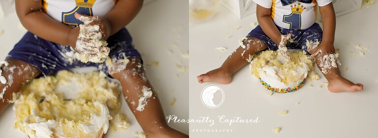 Baby boy sitting wit handstand feet covered in cake during a cake smash session.