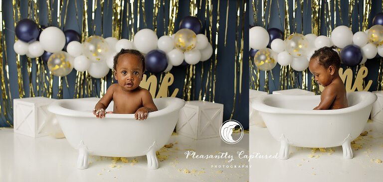 Close-up of baby boy smiling during a bubble bath cleanup after a cake smash photography session.