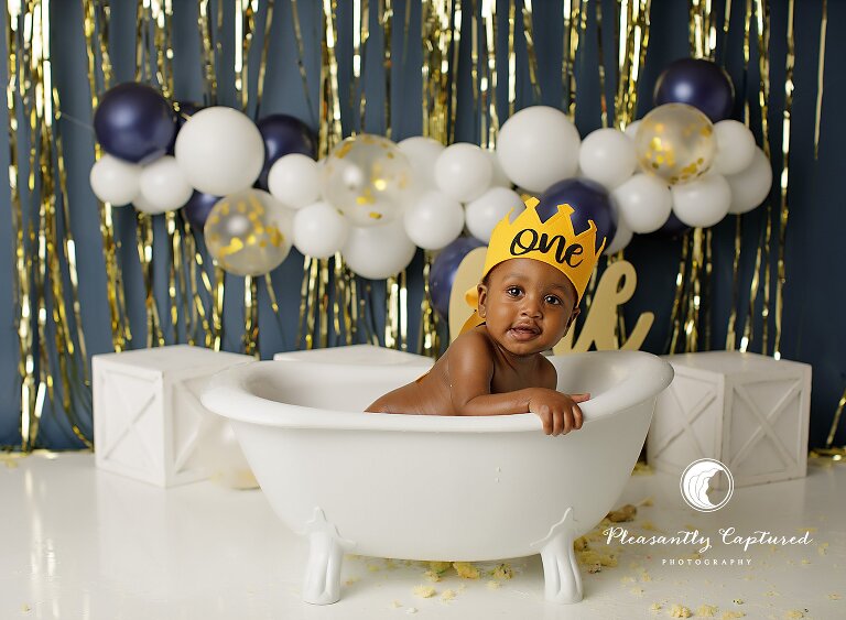 Clean, joyful portrait of a baby boy after a cake smash and bubble bath session.
