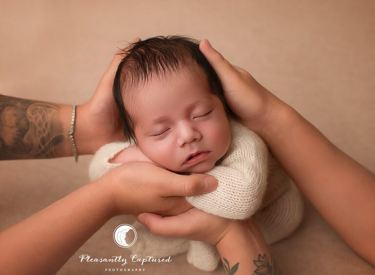 faceless family  with parent's hands holding baby boy newborn portraits jacksonville nc